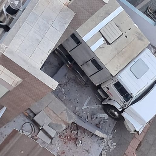 Caminhão atinge veículos e invade pátio de residência no centro de SMO